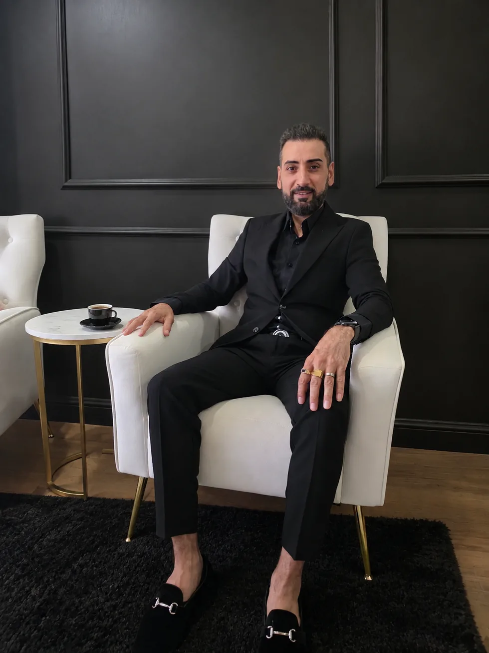 Ghassan Ashag seated in a refined lounge setting