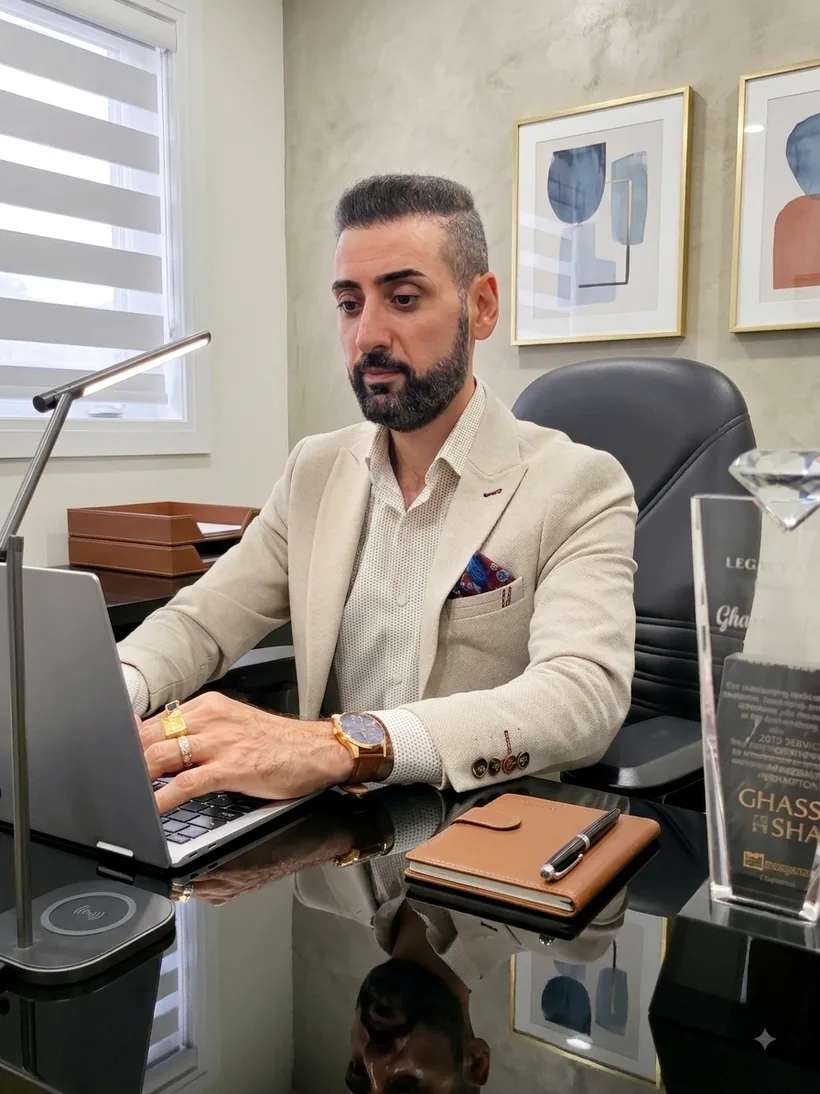 Ghassan Ashag working at his desk in a professional office setting